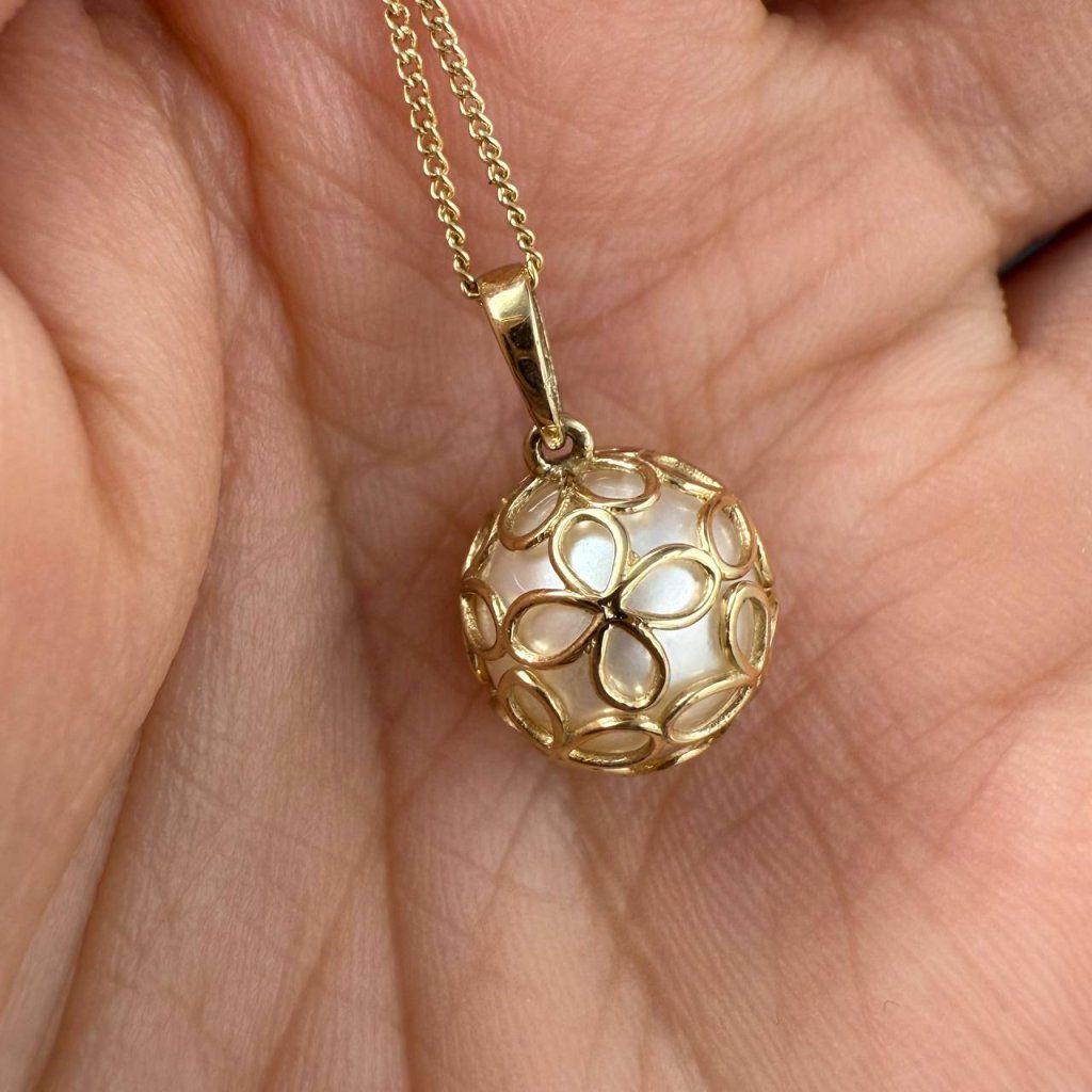 Gold Pendant with a River Pearl in a Delicate Openwork Sphere – photo 1 of 3