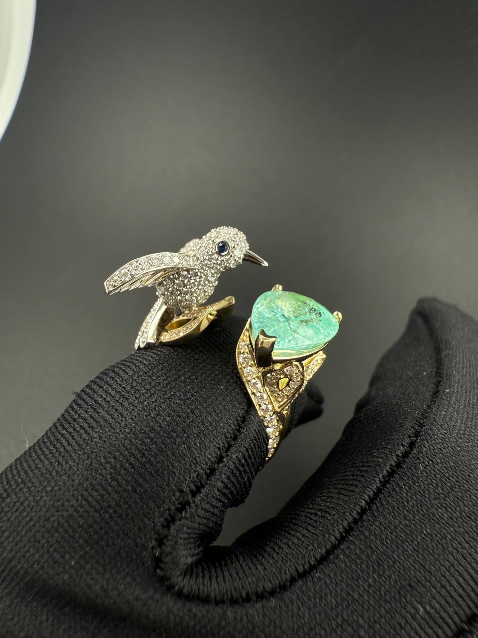 Paraíba bird ring displayed against black