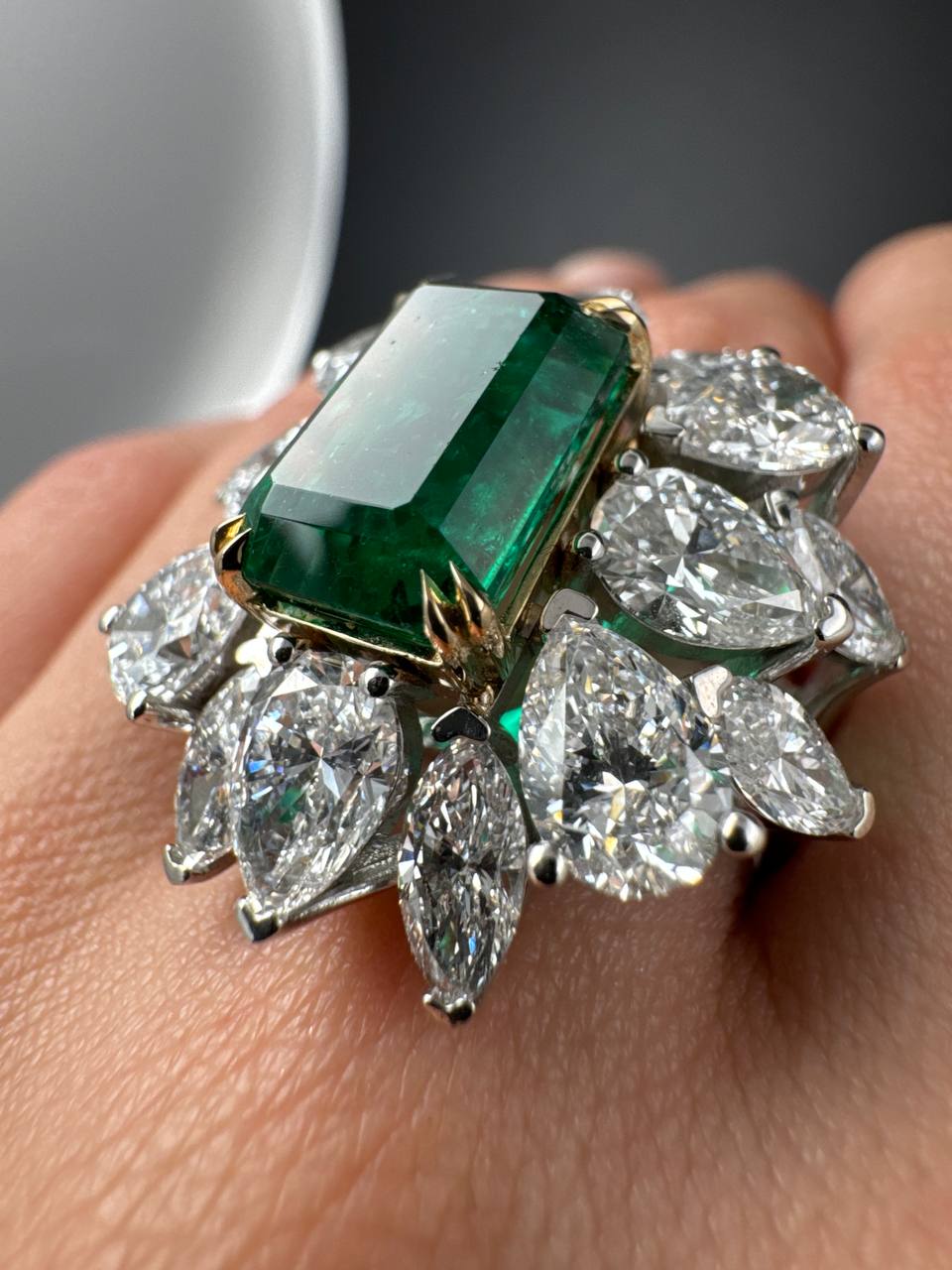 Close view of the emerald and marquise diamond halo, side angle