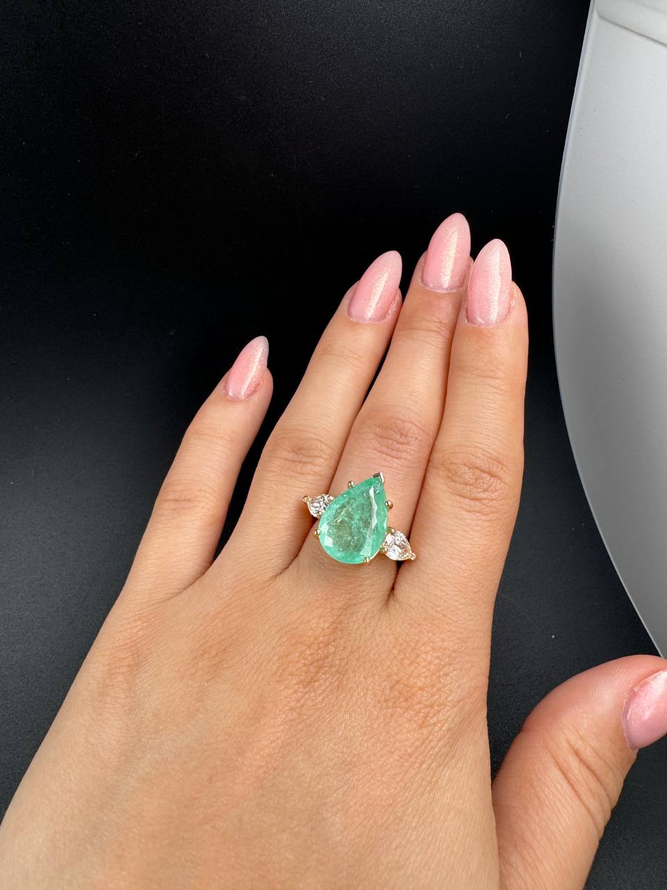 Paraíba trilogy ring on the hand against black